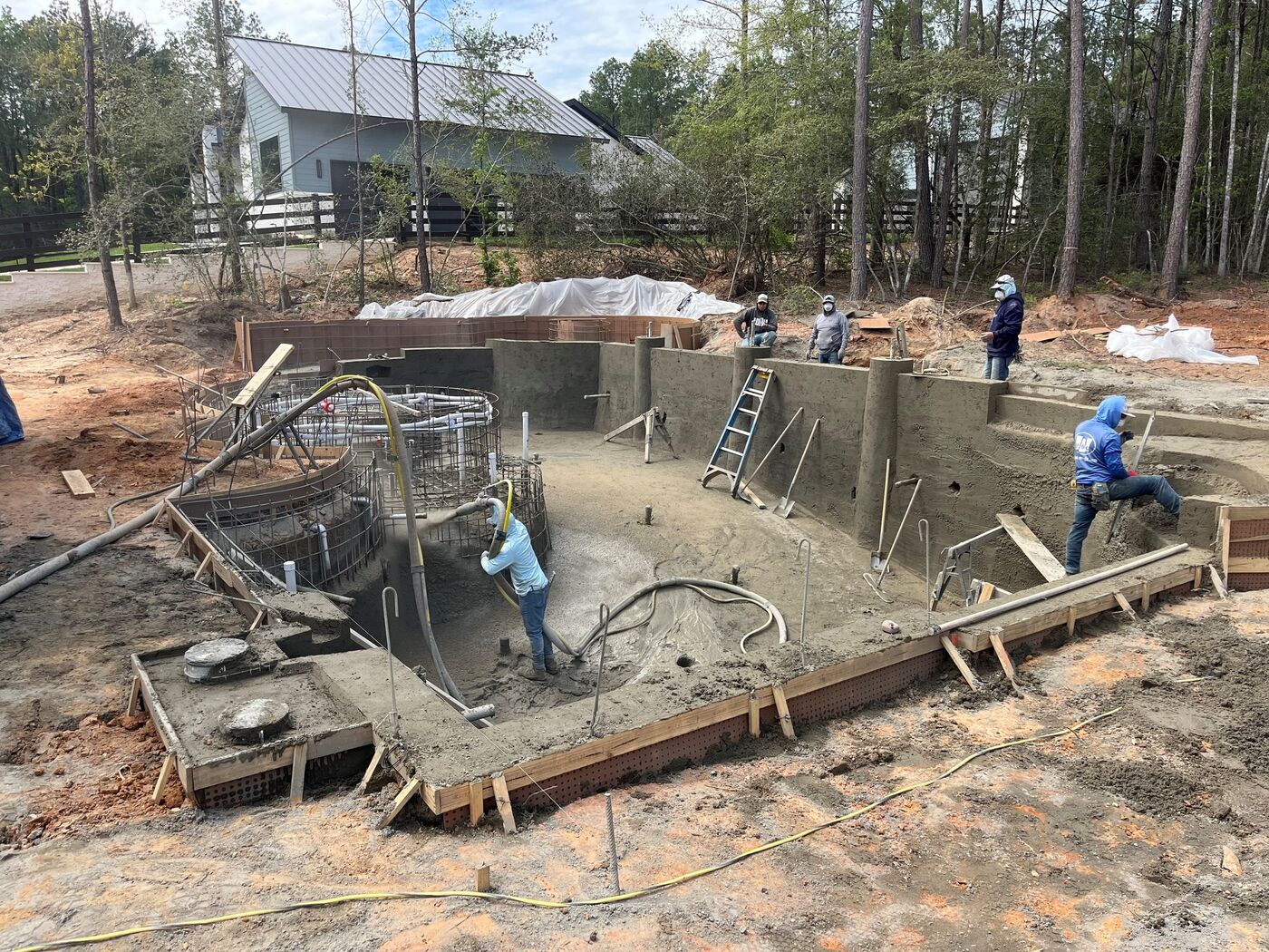 Pool construction crew completing gunite work